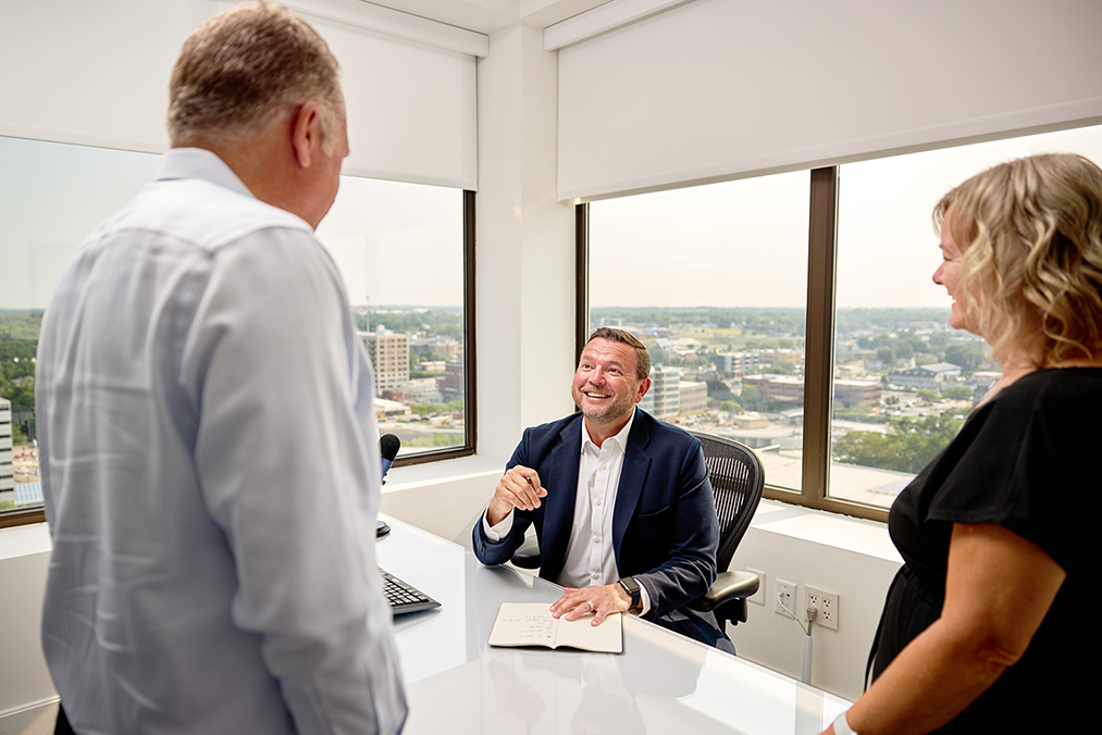 Gibson employees standing around a desk