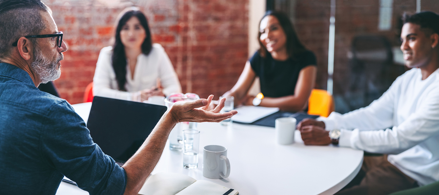 Professional man leading employees in meeting discussion